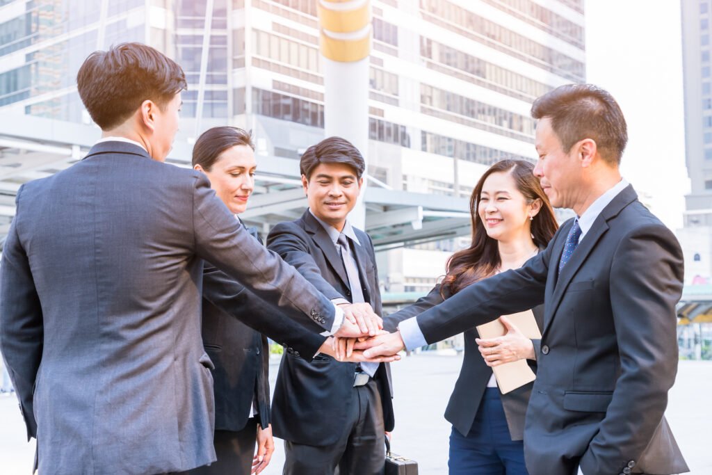 Group of businesspeople hand stack for teamwork in city